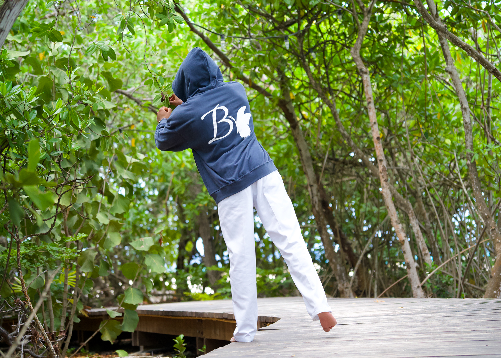 Butterfly Effect model mo01 reaching for branch in forest